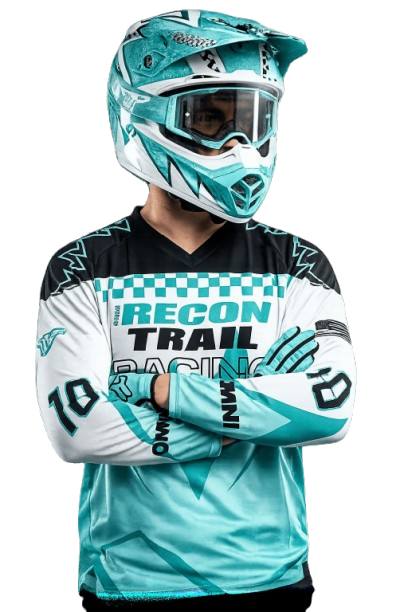 Off-road rider wearing RECON TRAIL racing gear, helmet, and goggles with arms crossed.