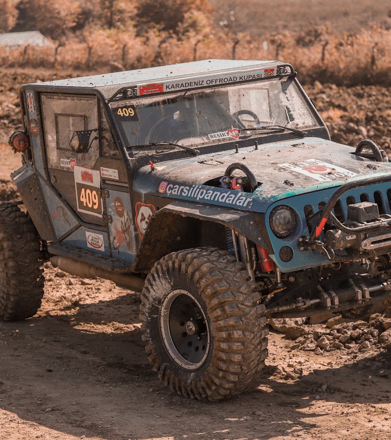 Recon Trail Off-Road Vehicle on Mud Terrain Off-road UTV driving through muddy terrain during an off-road event